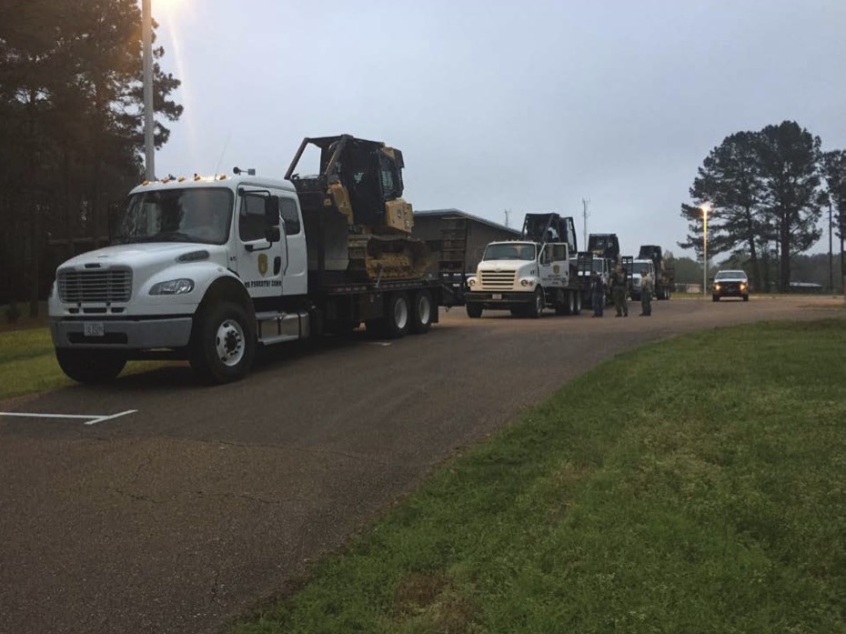 Trailer trucks loaded with heavy construction machinery